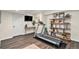 Finished basement featuring an exercise space with a treadmill, TV and custom storage shelves at 10286 Rotherwood Cir, Highlands Ranch, CO 80130