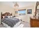 Bedroom with a wooden sleigh bed, complimented by coordinated furniture and a scenic window view at 10286 Rotherwood Cir, Highlands Ranch, CO 80130