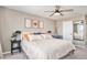 Spacious bedroom with a ceiling fan, modern art, and neutral decor for a relaxing atmosphere at 10286 Rotherwood Cir, Highlands Ranch, CO 80130