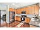 Modern kitchen with wood cabinets, stainless steel appliances, and plenty of natural light at 10286 Rotherwood Cir, Highlands Ranch, CO 80130