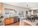 Bright kitchen with stainless steel appliances, a garden window, and an adjacent dining area and outside access at 10286 Rotherwood Cir, Highlands Ranch, CO 80130