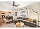 Open concept living area flowing into dining and kitchen, with a comfortable sectional sofa at 10286 Rotherwood Cir, Highlands Ranch, CO 80130