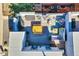 Aerial view of a rooftop deck featuring modern patio furniture and a grill at 2044 N High St, Denver, CO 80205