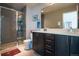 Bathroom featuring a tiled shower, double vanity, and a toilet with a matching color scheme at 2044 N High St, Denver, CO 80205