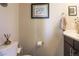 This bathroom features decorative artwork, a dark vanity with a white countertop and a neutral color scheme at 2044 N High St, Denver, CO 80205