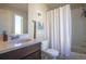 Well-lit bathroom with a shower and bathtub combination and modern fixtures at 2044 N High St, Denver, CO 80205