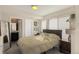 Bedroom with a large bed, windows with horizontal blinds, neutral paint and an ensuite bathroom at 2044 N High St, Denver, CO 80205