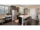 Modern kitchen features an island, stainless steel appliances, and dark cabinetry at 2044 N High St, Denver, CO 80205