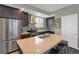 Modern kitchen features an island, stainless steel appliances, and dark cabinetry at 2044 N High St, Denver, CO 80205