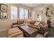 Comfortable living room with a large brown leather couch, a striped ottoman and a decorative rug at 2044 N High St, Denver, CO 80205
