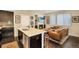Open floor plan featuring a living room with a fireplace, kitchen, and dining area at 2044 N High St, Denver, CO 80205