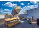 Outdoor rooftop deck featuring an umbrella, string lights, and patio furniture at 2044 N High St, Denver, CO 80205
