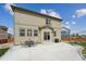 Home's backyard featuring an outdoor dining area on a concrete patio, ideal for entertaining at 2201 Monte Vista St, Fort Lupton, CO 80621