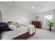 Calm bedroom with a queen bed, dresser, and plant, offering a peaceful retreat at 2201 Monte Vista St, Fort Lupton, CO 80621