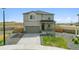 Two story home with an attached garage, concrete driveway, and grass and rock landscaping at 2201 Monte Vista St, Fort Lupton, CO 80621