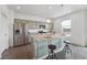 Kitchen island with gray cabinets, granite countertop, and stainless steel appliances at 2201 Monte Vista St, Fort Lupton, CO 80621