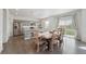Kitchen with stainless steel appliances, gray cabinets, and a wooden table with chairs at 2201 Monte Vista St, Fort Lupton, CO 80621