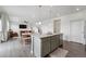 Kitchen island with gray cabinets with an open floor plan to dining and living room area at 2201 Monte Vista St, Fort Lupton, CO 80621