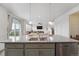 Kitchen island with granite countertops and stainless steel appliances; an entertainers dream at 2201 Monte Vista St, Fort Lupton, CO 80621
