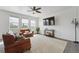 Bright living room with leather furniture, ceiling fan and white paneled walls at 2201 Monte Vista St, Fort Lupton, CO 80621