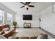 Bright living room with leather furniture, ceiling fan, white walls and a large rug at 2201 Monte Vista St, Fort Lupton, CO 80621