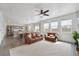 Open concept living room with white paneled walls next to kitchen with gray cabinets at 2201 Monte Vista St, Fort Lupton, CO 80621