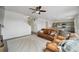 Living room adjacent to kitchen and dining area with white walls and brown furniture at 2201 Monte Vista St, Fort Lupton, CO 80621