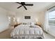 Main bedroom with large bed, bedside tables, ceiling fan, and large windows at 2201 Monte Vista St, Fort Lupton, CO 80621