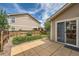 Backyard patio area with grass and wood fence with a sliding glass door to the home at 5957 Turnstone Pl, Castle Rock, CO 80104