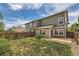 Landscaped backyard featuring green lawn, patio, and wood fence at 5957 Turnstone Pl, Castle Rock, CO 80104