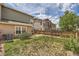 Spacious backyard featuring green lawn, patio, and wood fence at 5957 Turnstone Pl, Castle Rock, CO 80104