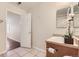 Bathroom with updated fixtures, vanity, tiled floors, and view into adjacent bedroom at 5957 Turnstone Pl, Castle Rock, CO 80104