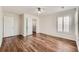 Bedroom with hardwood floors, ceiling fan, shutters, and a walk-in closet at 5957 Turnstone Pl, Castle Rock, CO 80104
