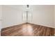 Cozy bedroom featuring hardwood floors, neutral walls, and window shutters at 5957 Turnstone Pl, Castle Rock, CO 80104