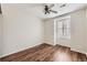A bright bedroom with hardwood floors and a ceiling fan has white walls and window at 5957 Turnstone Pl, Castle Rock, CO 80104