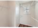Walk-in closet with ample shelving and hanging space, plus natural light from the window at 5957 Turnstone Pl, Castle Rock, CO 80104