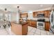 Well-lit kitchen featuring granite countertops, tile flooring, and stainless steel appliances at 5957 Turnstone Pl, Castle Rock, CO 80104