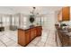 Open kitchen with an island, tile floors, and ample counter space at 5957 Turnstone Pl, Castle Rock, CO 80104
