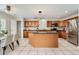 Spacious kitchen features a granite island, stainless steel appliances and bright tile floors at 5957 Turnstone Pl, Castle Rock, CO 80104