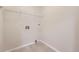 Laundry room with tile floors, shelving, hookups, and neutral paint color at 5957 Turnstone Pl, Castle Rock, CO 80104