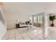 Spacious living room with tile floors leading to outside patio area at 5957 Turnstone Pl, Castle Rock, CO 80104