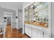 Elegant bar area featuring mirrored shelving, a sink, and wood countertops, perfect for entertaining guests at 5531 S Telluride Ct, Centennial, CO 80015