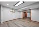 Basement room with laminate floors, wood trim and updated lighting at 5531 S Telluride Ct, Centennial, CO 80015