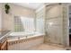 Stylish bathroom showcasing a soaking tub, a separate shower, and elegant tile accents at 5531 S Telluride Ct, Centennial, CO 80015