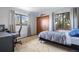 Comfortable bedroom features carpet, neutral walls, a closet, and two windows for natural light at 5531 S Telluride Ct, Centennial, CO 80015