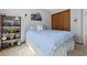 Neat bedroom design featuring carpet, a closet, a bookcase and soft blue bedding at 5531 S Telluride Ct, Centennial, CO 80015