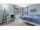 Cozy bedroom with carpet, light blue walls, and ample sunlight from two windows and desk with chair at 5531 S Telluride Ct, Centennial, CO 80015