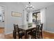 Bright dining room featuring a modern chandelier, natural light, and stylish decor with wood flooring at 5531 S Telluride Ct, Centennial, CO 80015