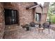 Brick entrance with a decorative metal door, outdoor seating, and a landscaped walkway at 5531 S Telluride Ct, Centennial, CO 80015