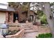 Charming brick home featuring a well-maintained lawn, brick staircase, and mature landscaping at 5531 S Telluride Ct, Centennial, CO 80015